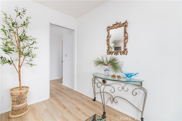 corridor with light hardwood / wood-style floors