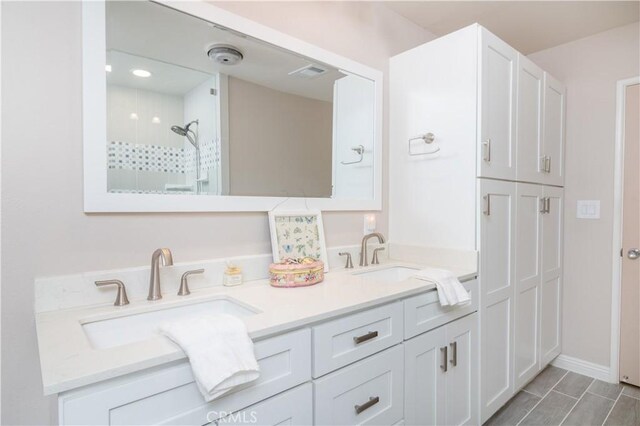 bathroom with a shower and vanity