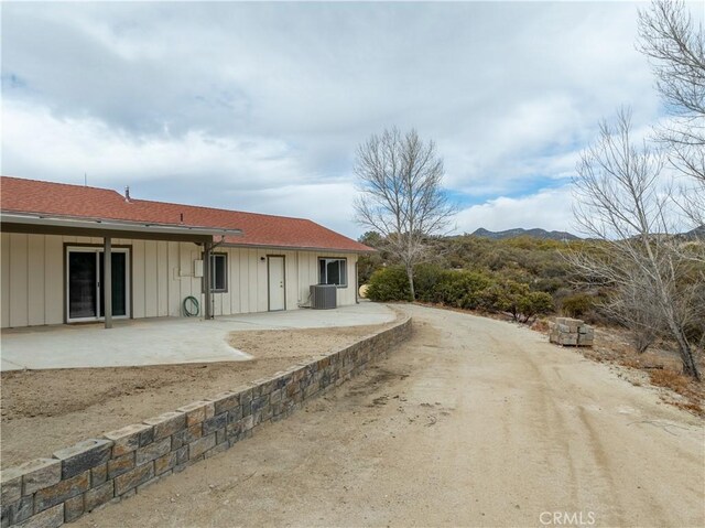 back of property featuring central AC and a patio area