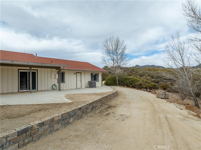 rear view of property with central AC and a patio