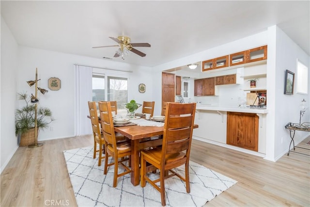 dining room featuring ceiling fan and light wood-type flooring