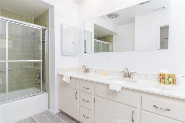 bathroom featuring vanity and enclosed tub / shower combo