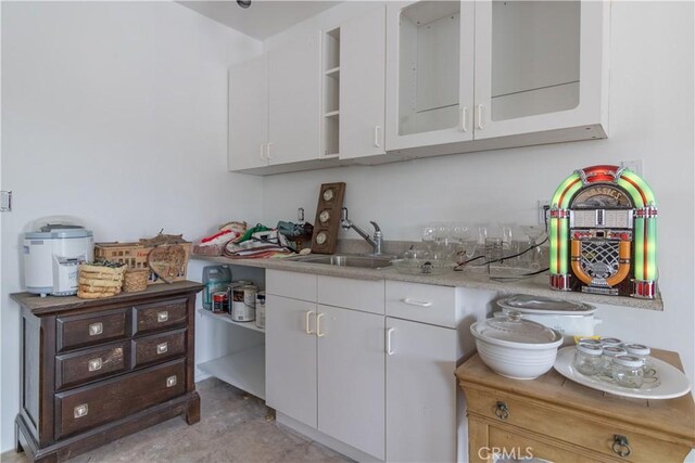 kitchen featuring sink and white cabinetry