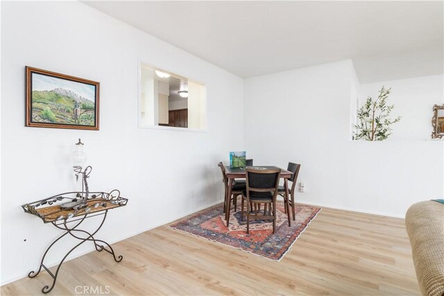 dining area with hardwood / wood-style flooring