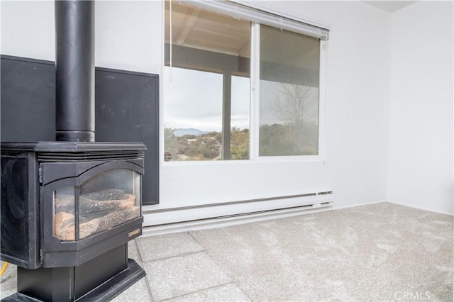 carpeted living room featuring a baseboard heating unit and a wood stove