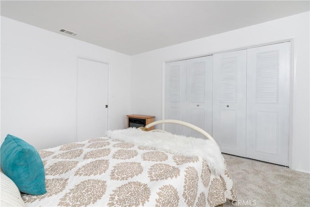 bedroom with a closet and light colored carpet