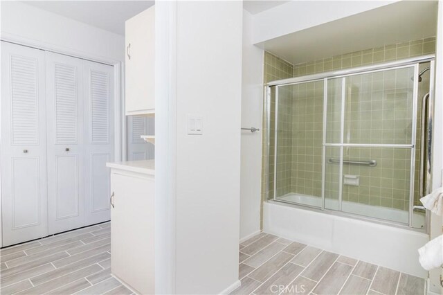 bathroom with shower / bath combination with glass door