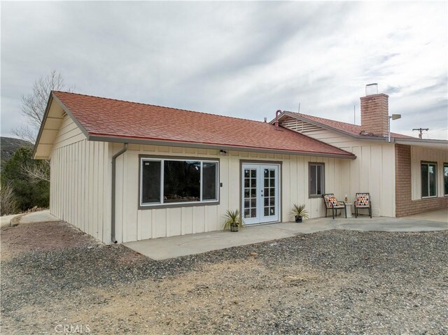 rear view of property featuring a patio area and french doors