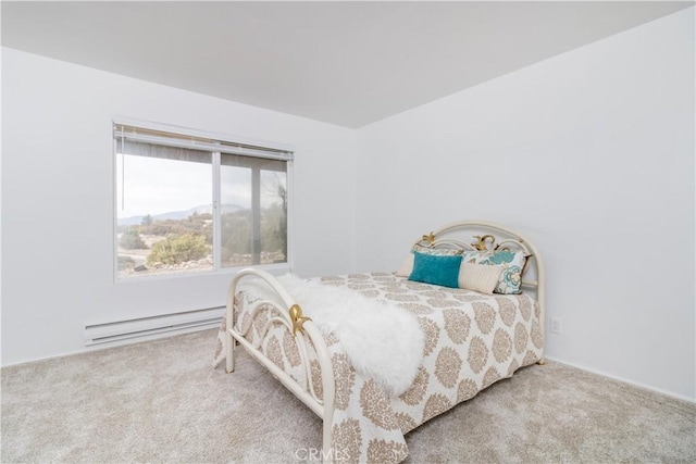 bedroom featuring light colored carpet and a baseboard heating unit