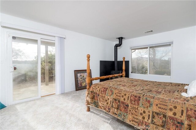 bedroom with light colored carpet and access to outside