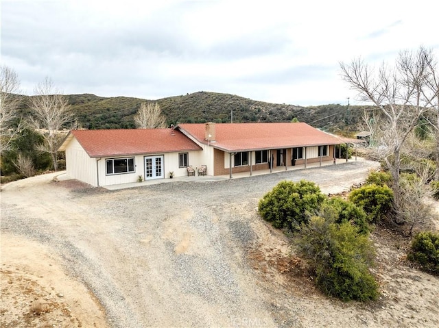 single story home with french doors and a mountain view