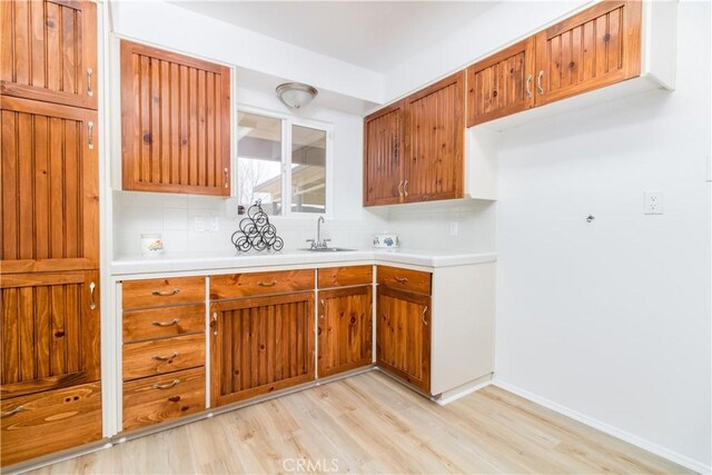 kitchen with light wood-type flooring and sink