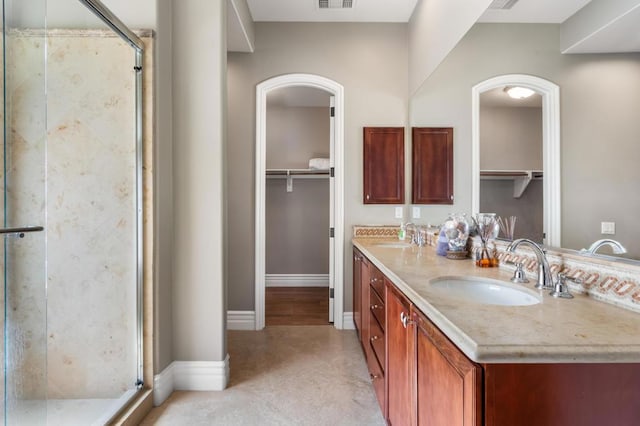 bathroom with vanity and walk in shower