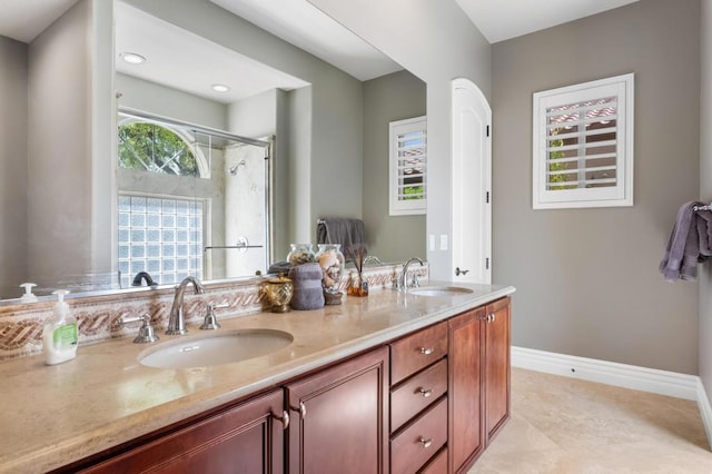 bathroom featuring tile patterned flooring, vanity, and walk in shower