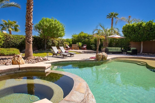 view of pool with outdoor lounge area and a patio