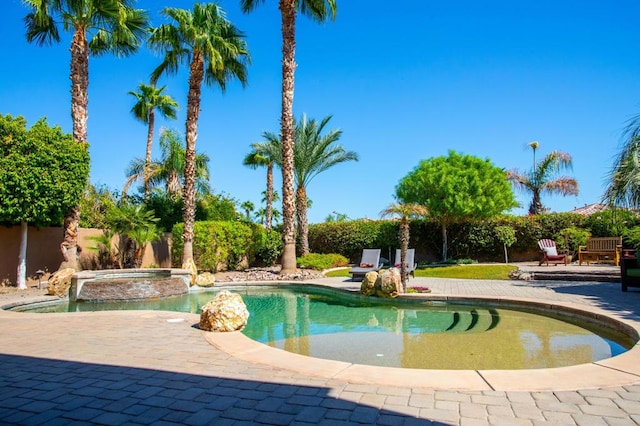 view of swimming pool with a patio and an in ground hot tub