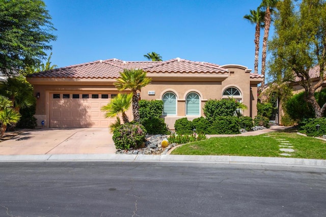 mediterranean / spanish-style house featuring a garage