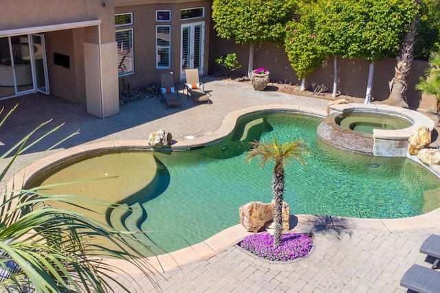 view of swimming pool with an in ground hot tub