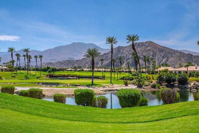 surrounding community with a yard and a water and mountain view