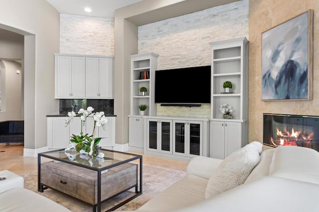 living room with built in shelves and a fireplace