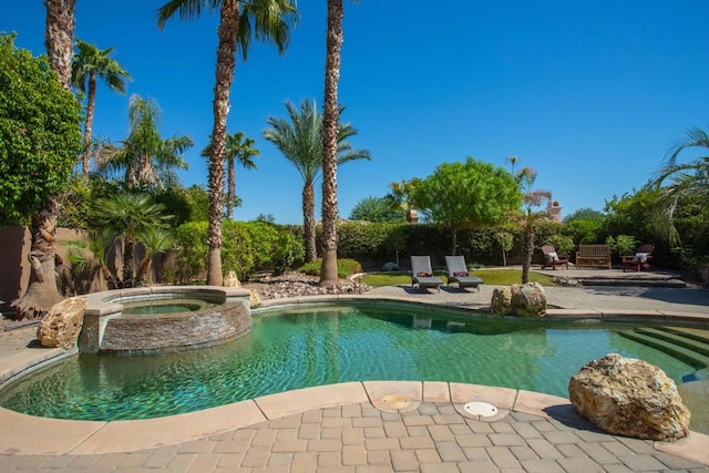 view of pool featuring an in ground hot tub and a patio