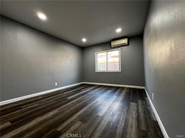 empty room with dark hardwood / wood-style flooring and an AC wall unit