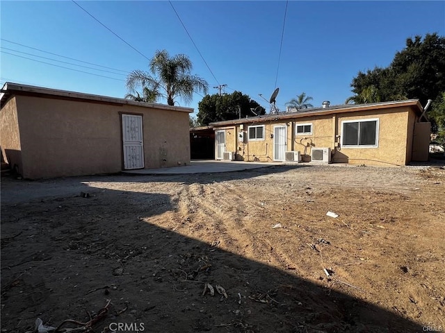 rear view of property featuring ac unit