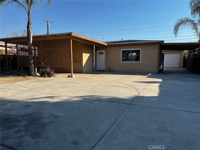 view of front of property with a carport and a garage