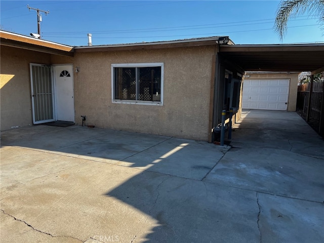 exterior space with a garage and a carport