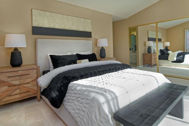 bedroom featuring lofted ceiling, light colored carpet, and a closet