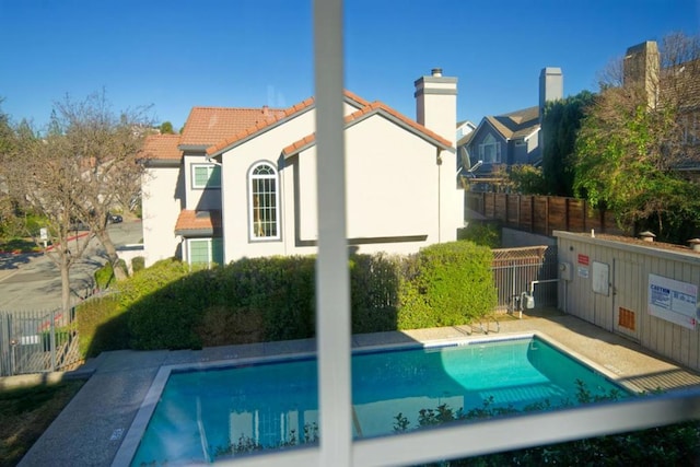 back of house with a community pool