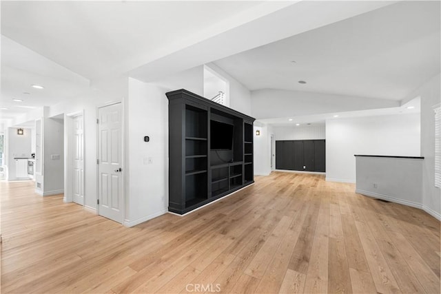 interior space with lofted ceiling and light hardwood / wood-style floors