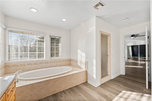 bathroom with vanity, hardwood / wood-style flooring, and separate shower and tub