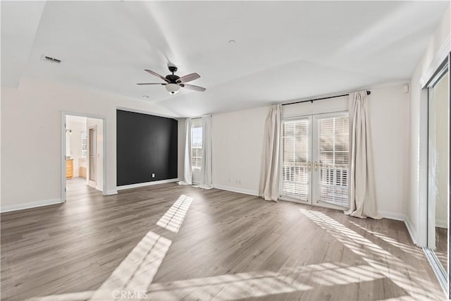 unfurnished room featuring hardwood / wood-style flooring, vaulted ceiling, french doors, and ceiling fan