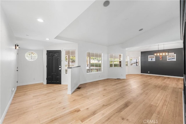 foyer featuring lofted ceiling and light hardwood / wood-style flooring