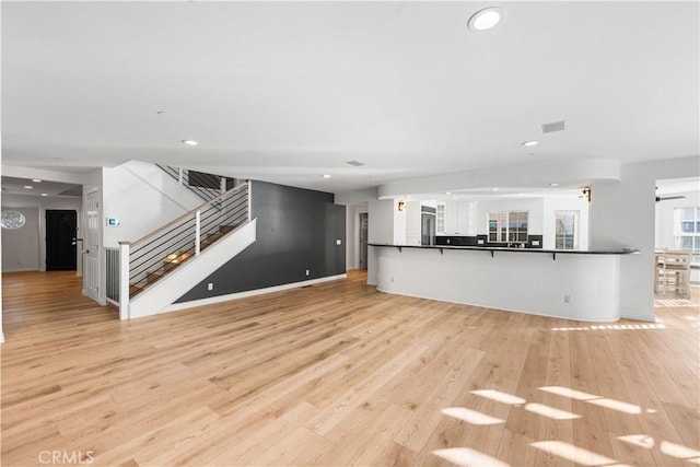 unfurnished living room featuring light hardwood / wood-style flooring