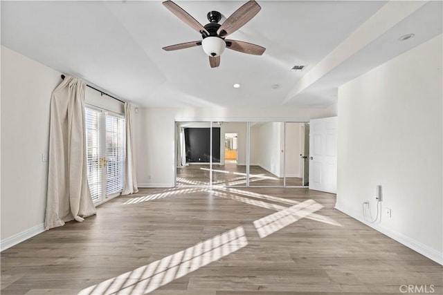 unfurnished room with ceiling fan and light hardwood / wood-style floors