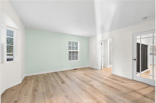 unfurnished room with light hardwood / wood-style flooring