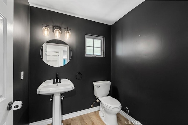 bathroom featuring sink, wood-type flooring, and toilet