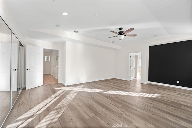 spare room with ceiling fan, lofted ceiling, and light wood-type flooring