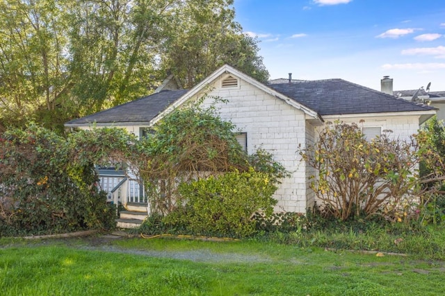 view of side of home featuring a yard