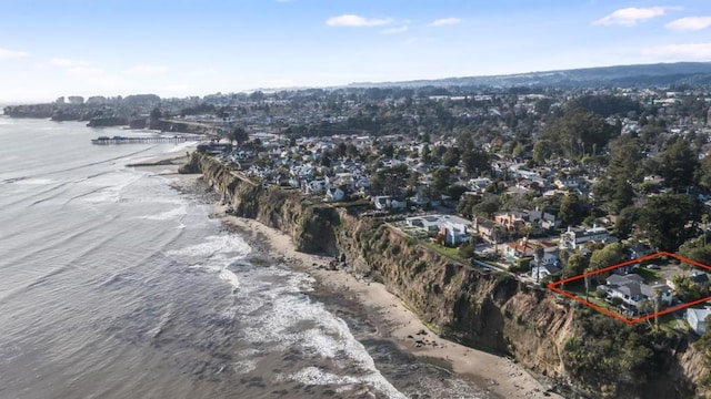 drone / aerial view featuring a water view and a beach view