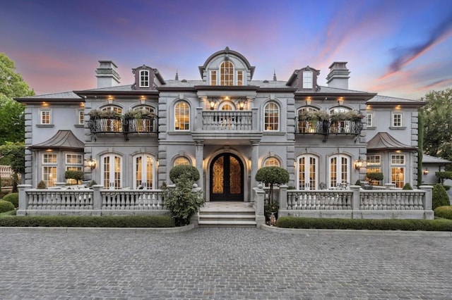 view of front of property with french doors and a balcony