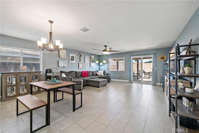 living room featuring ceiling fan with notable chandelier