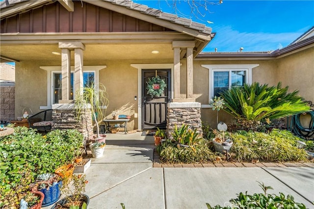 view of exterior entry with a porch