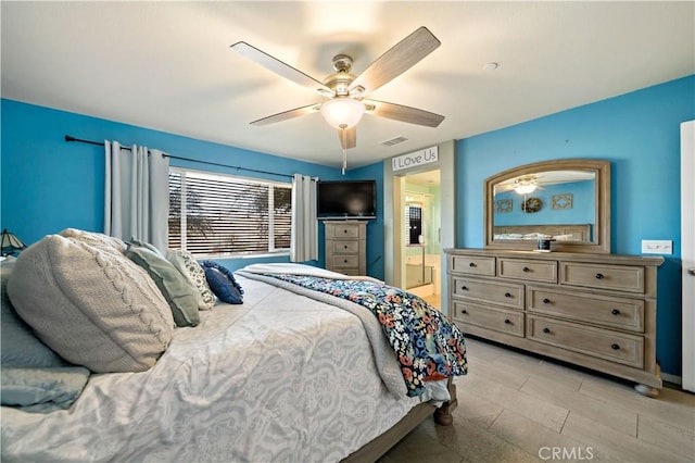 bedroom with ensuite bath and ceiling fan