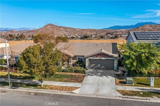 view of front of property featuring a garage and a mountain view