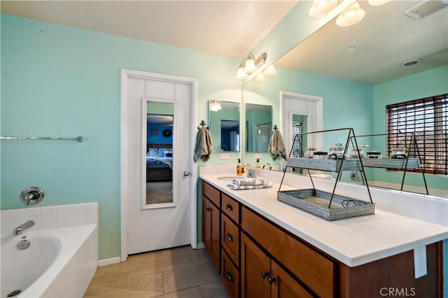 bathroom featuring vanity, a bath, and tile patterned floors