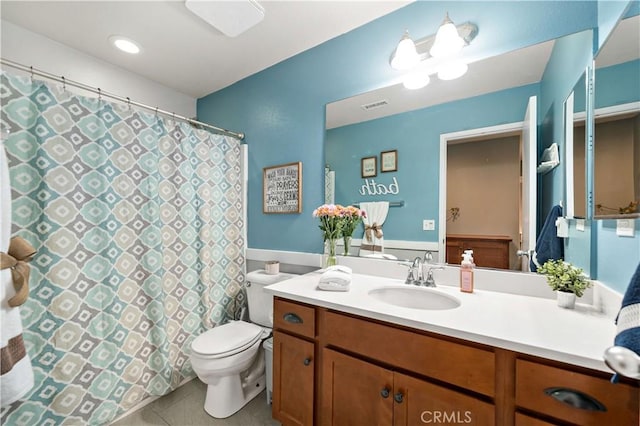 bathroom with tile patterned floors, vanity, and toilet