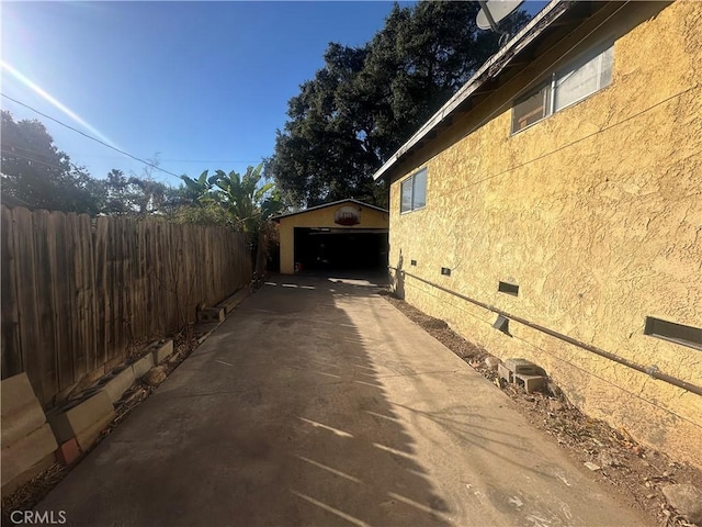 view of property exterior with an outdoor structure and a garage